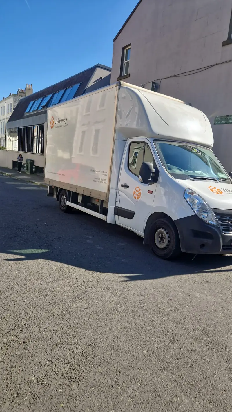 A Hanway removal van on a sunny residential street
