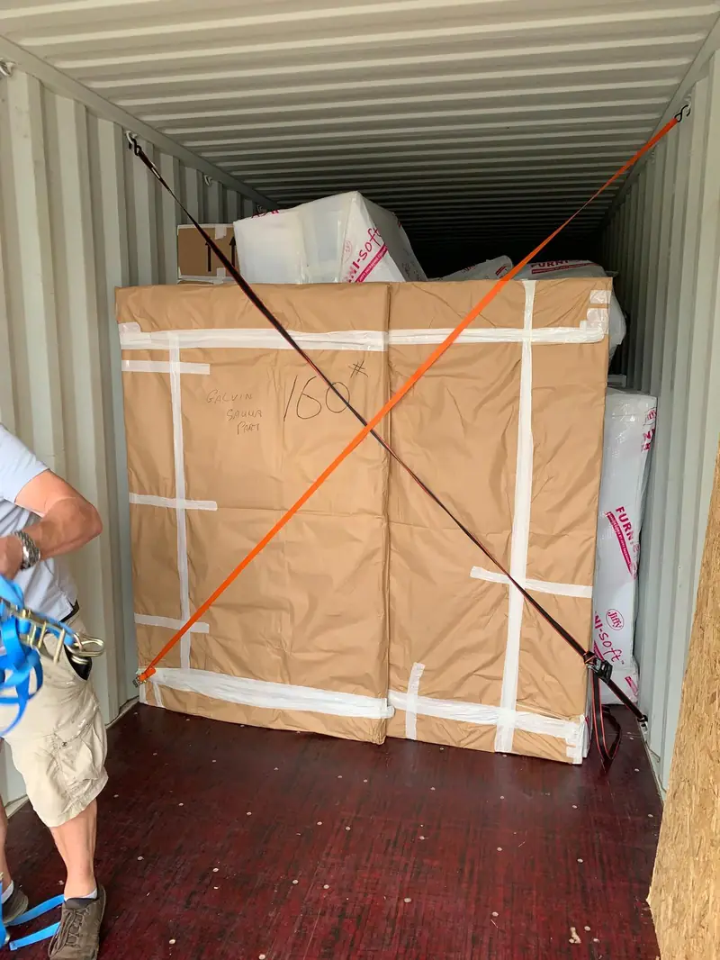 Furniture boxed and strapped inside a shipping container for an overseas move