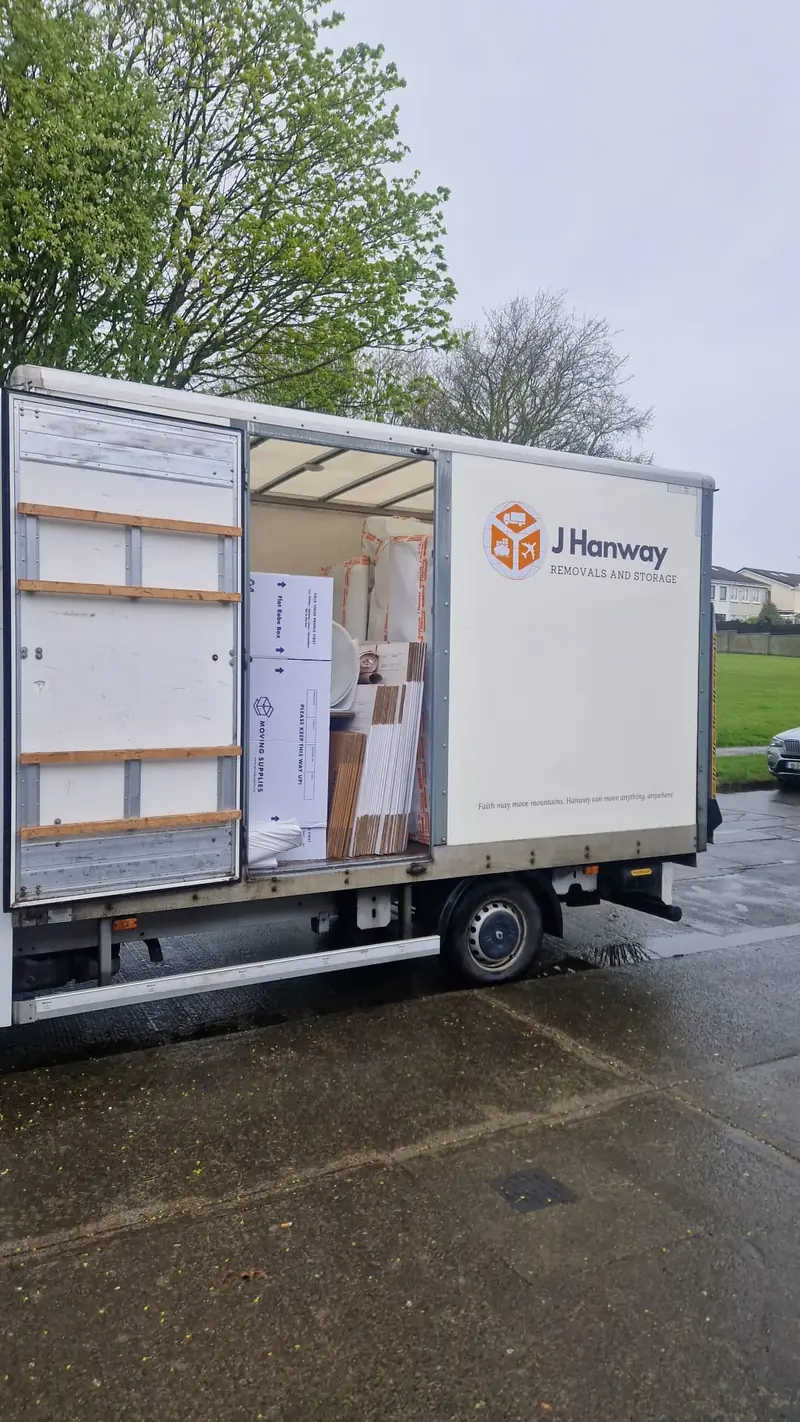 A Hanway van with its side open, loaded with boxes